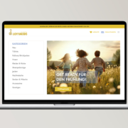 Laptop zeigt Lottakids-Webseite mit Frühlingsangeboten für Kinderbekleidung.
