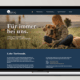 Laptop zeigt Webseite einer Tierbestattungsagentur mit Kind und Hund im Freien.