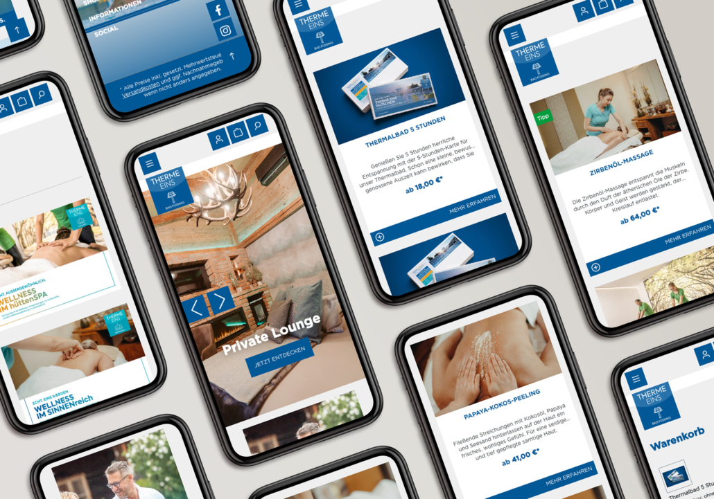 Vielzahl von Smartphones mit Wellness-Anwendungen der Therme Eins auf verschiedenen Bildschirmen.